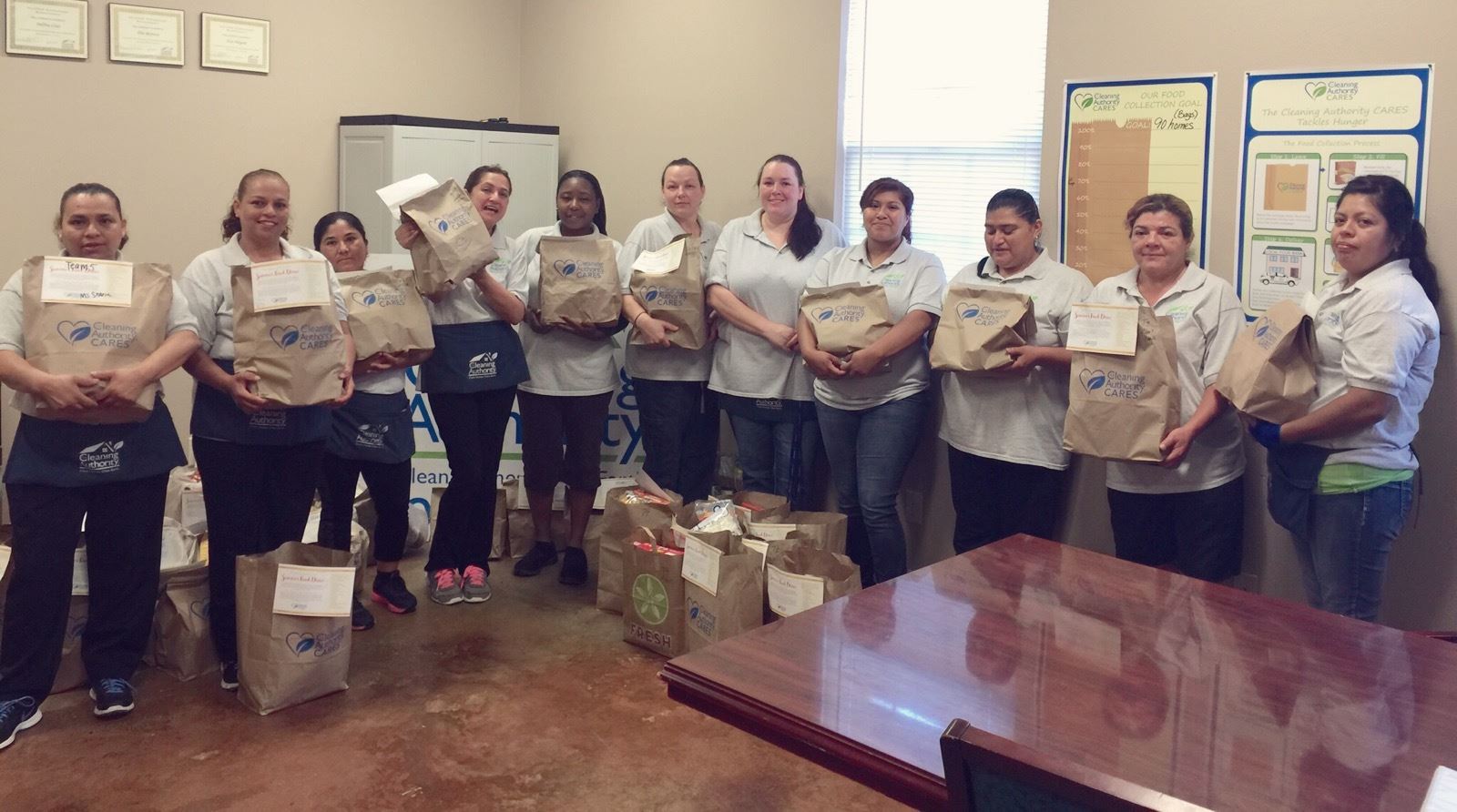 The TCA Tyler team poses in their offices with the donations they collected for a local charity.