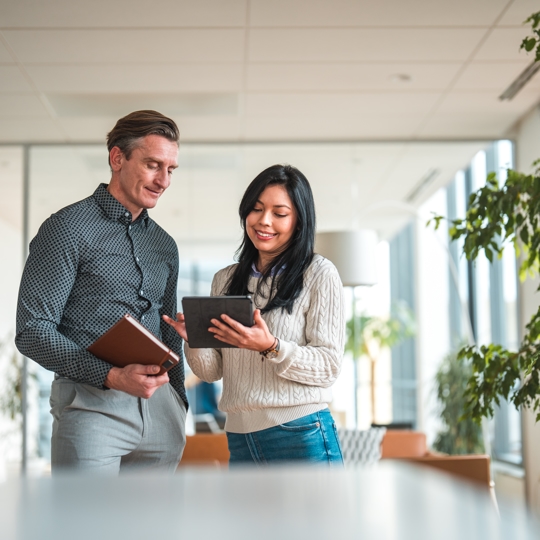 women smiling on computer showing a man looking at a computer