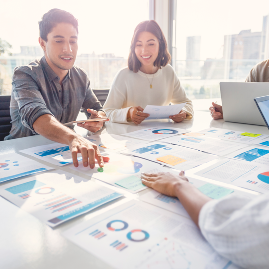 people smiling sitting around a desk