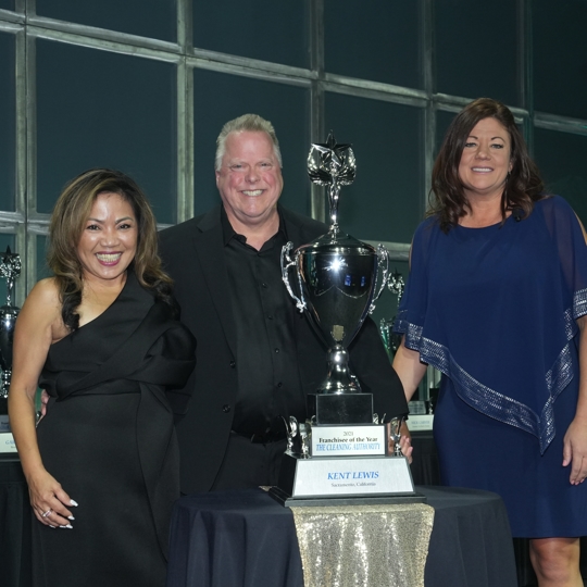 three people standing smiling