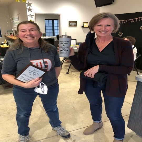 Two women next to each other smiling