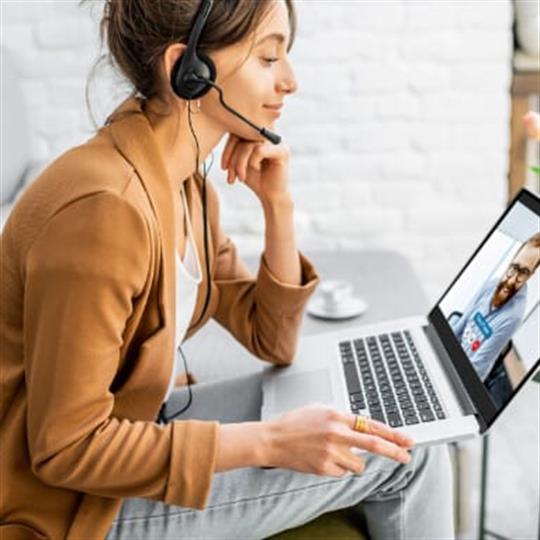 women smiling looking at a computer