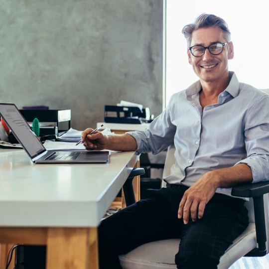 Guy sitting at desk smiling