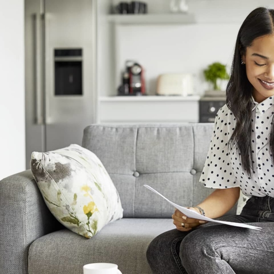 Women smiling down at paper