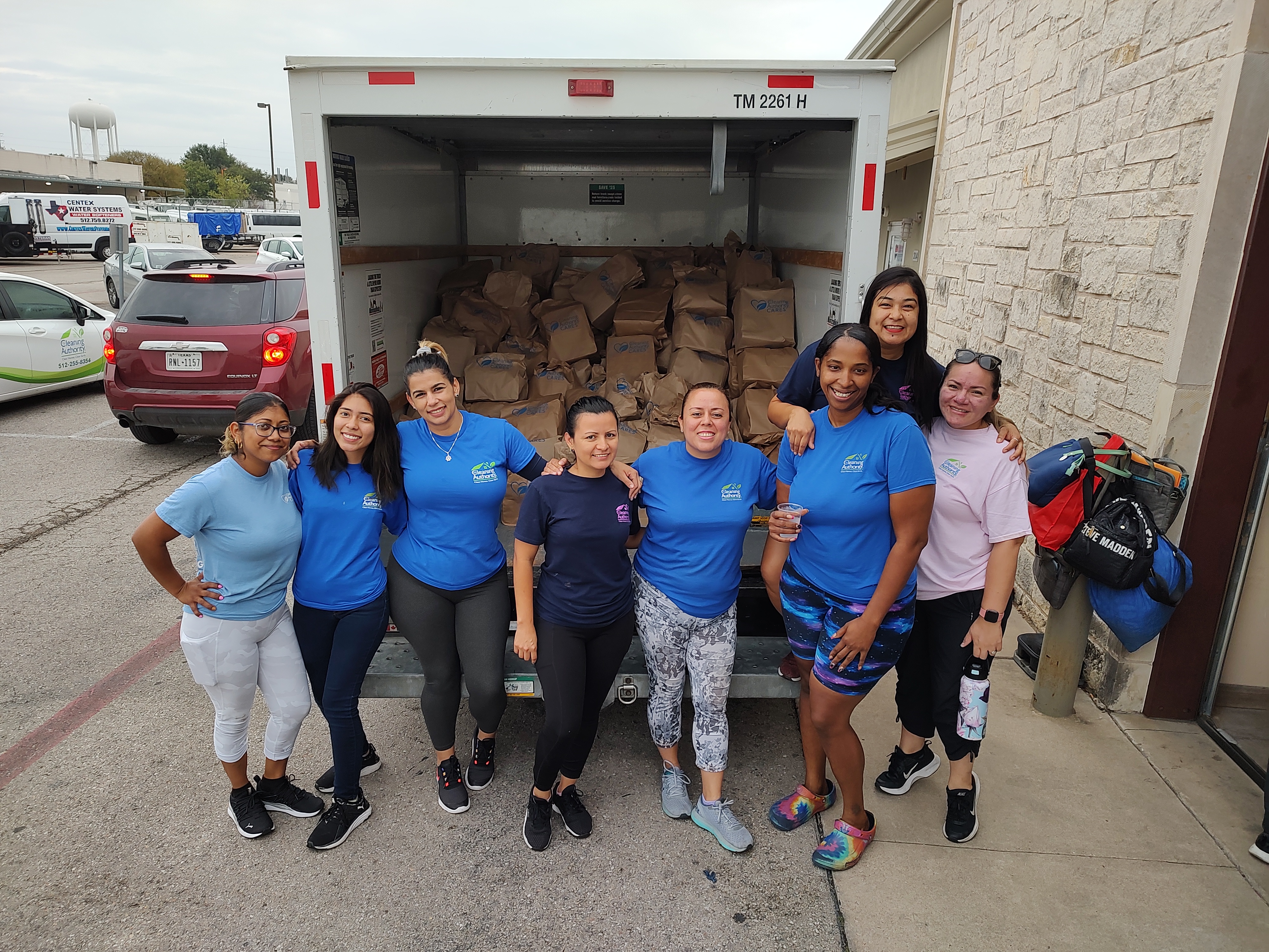 Image of TCA Team infront of Truck full of Donation Bags