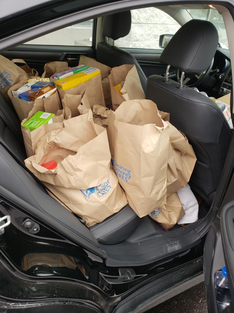 The donations collected by the TCA Grayslake team sit in the back seat of a black car.