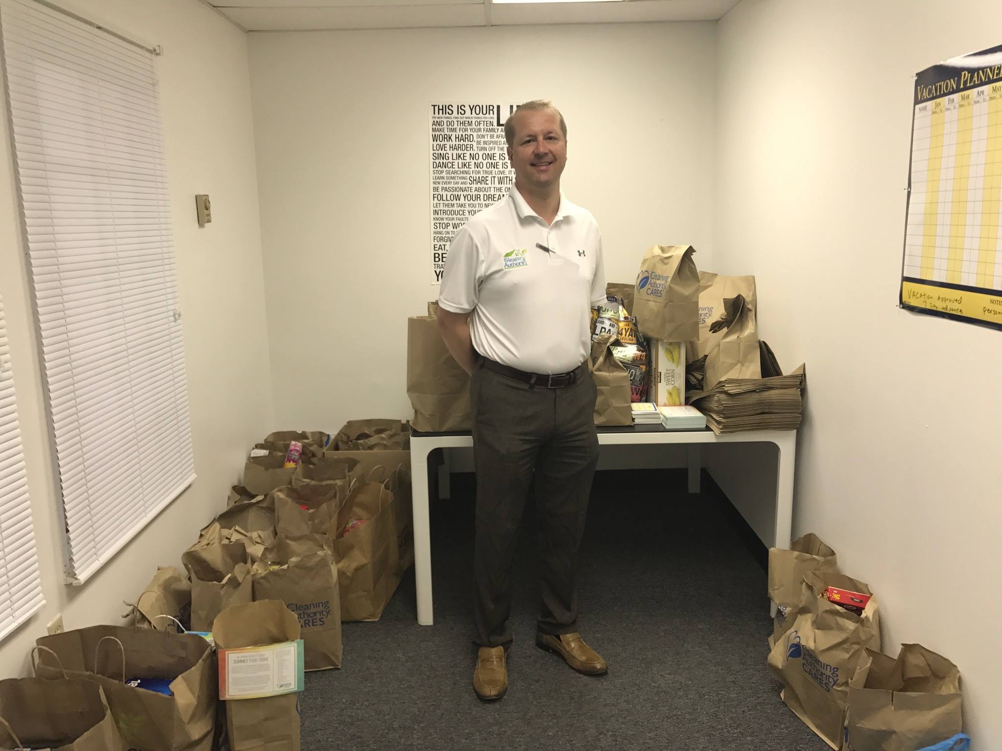 A member of the TCA of Mentor team stands with donations collected for a local charity.